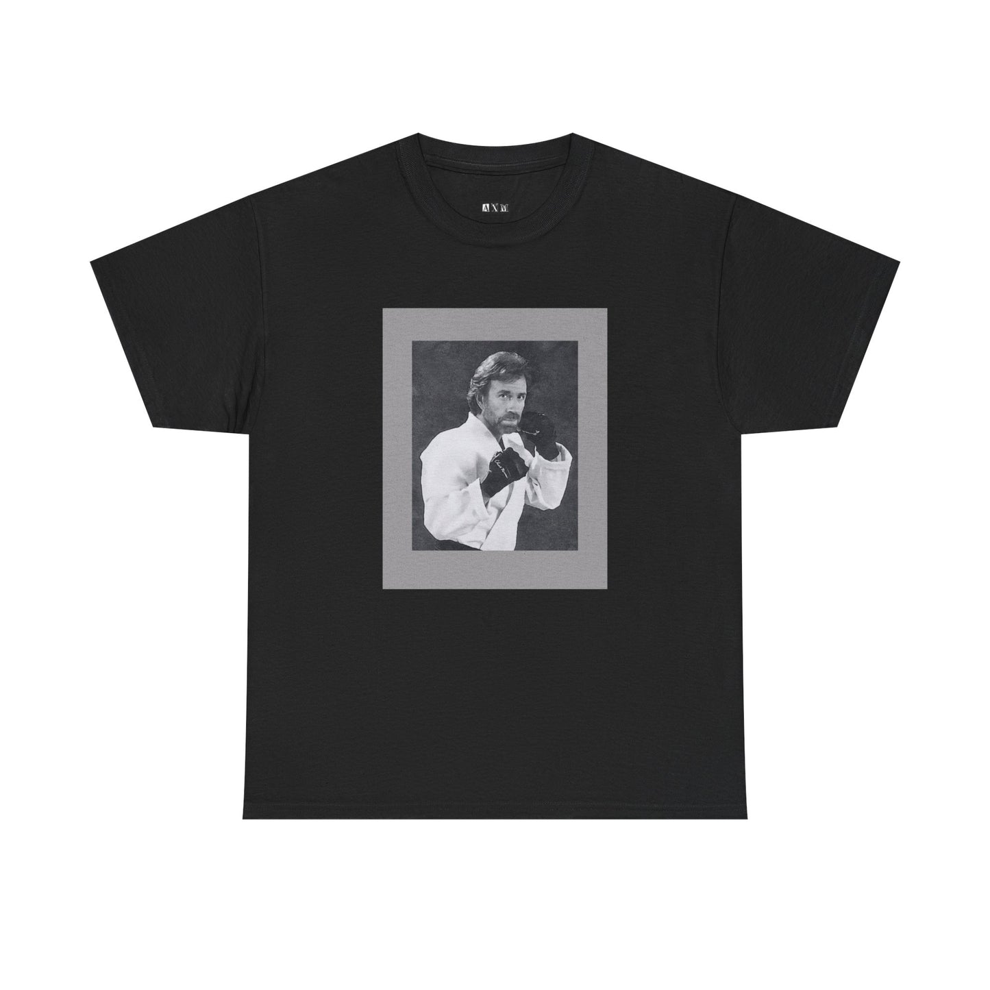 Chuck Norris unisex heavyweight tee shirt featuring a fierce fighting stance, frozen in black-and-white glory. A tribute to raw strength and unshakable legend, it’s more than a shirt—it’s a statement of fearless dominance.