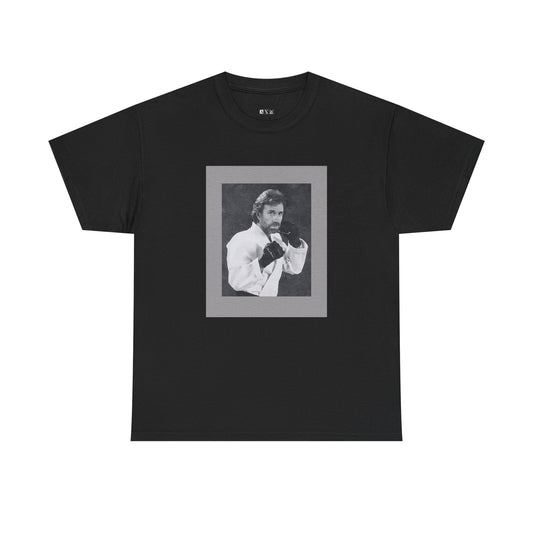 Chuck Norris unisex heavyweight tee shirt featuring a fierce fighting stance, frozen in black-and-white glory. A tribute to raw strength and unshakable legend, it’s more than a shirt—it’s a statement of fearless dominance.