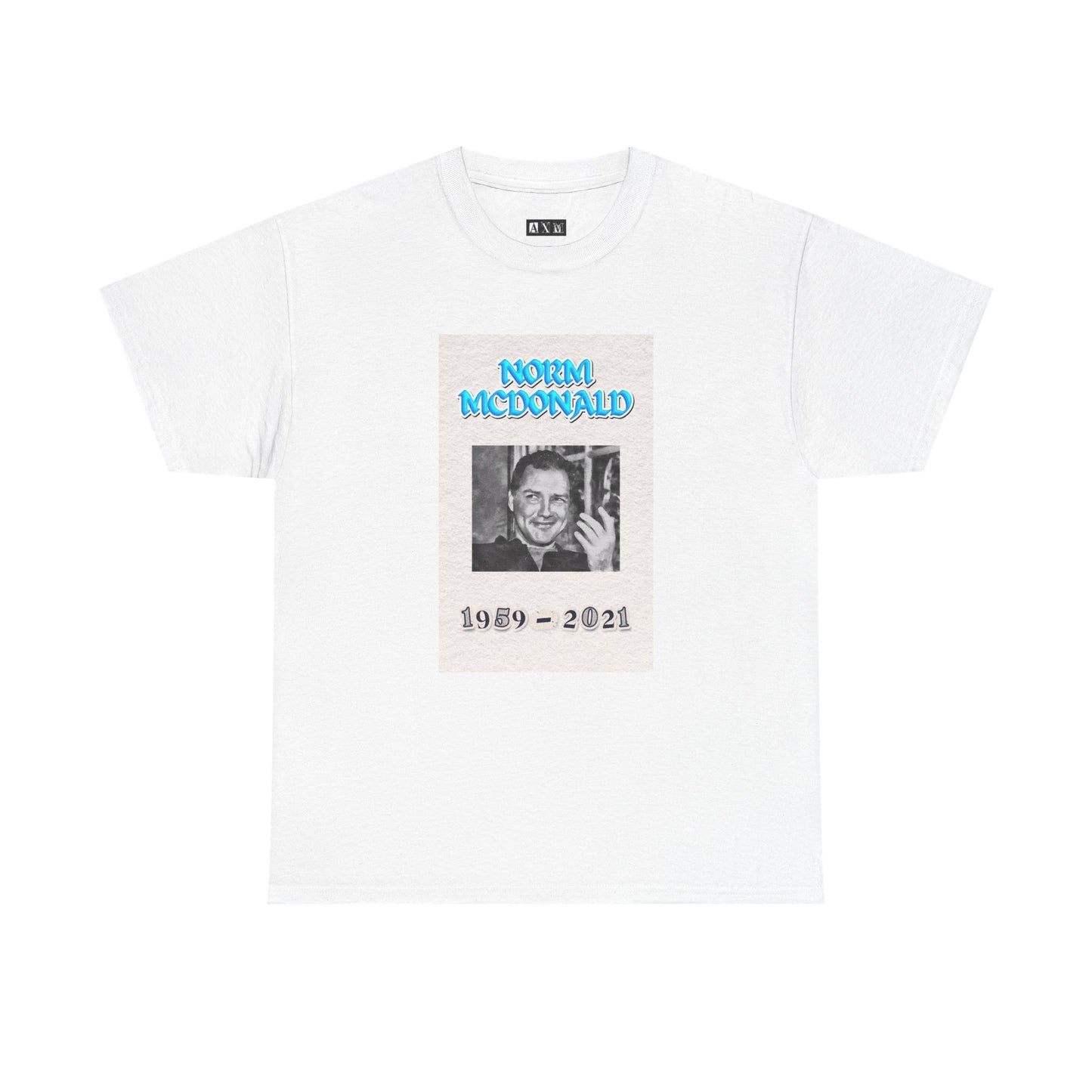 Norm McDonald black unisex heavyweight tee shirt honoring the comedy legend. It features a smiling portrait with electric blue lettering and the years 1959–2021. A timeless tribute to be enjoyed by any Norm McDonald fan.